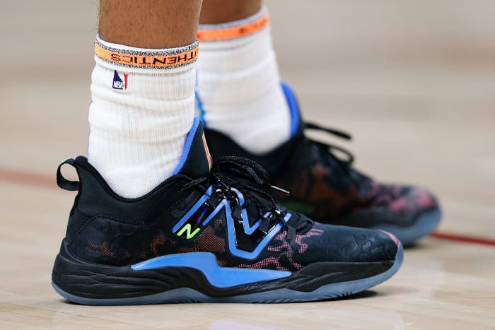 View of black and blue New Balance shoes.